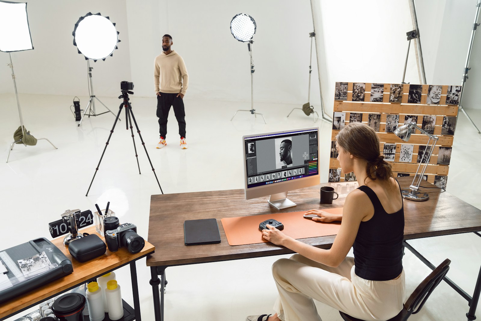 Professional photography studio with photographer and creative workspace